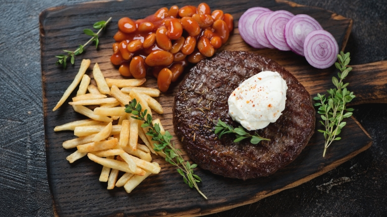 serbia-pljeskavica-cheese-fries-red onion-rustic wooden serving board